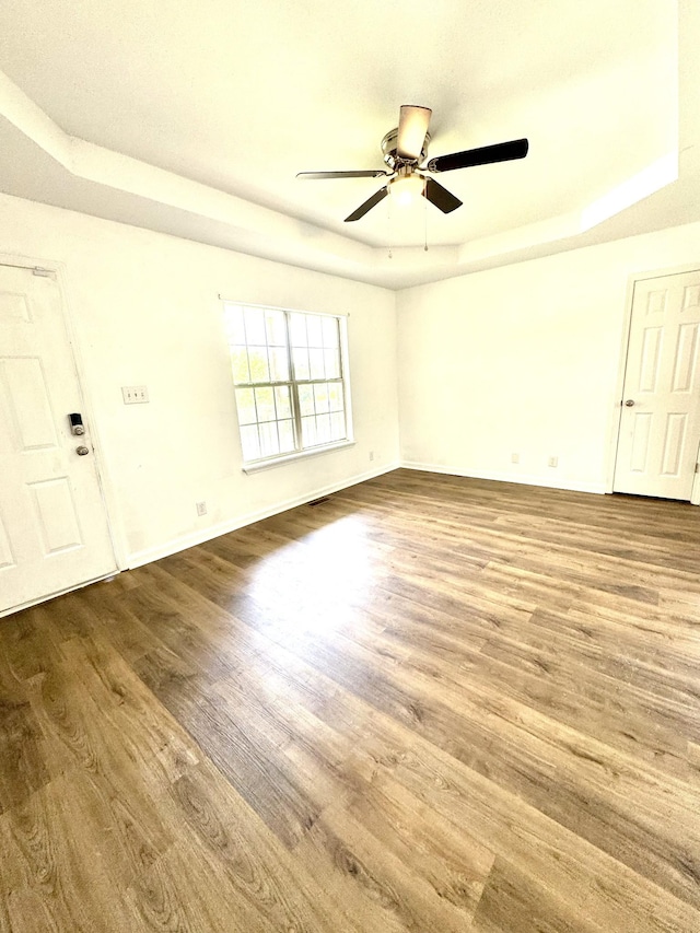 1306 Jared Ct, Clarksville, TN 37042 - spare room with wood finished floors, ceiling fan, baseboards, and a tray ceiling