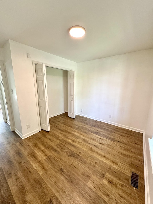 1306 Jared Ct, Clarksville, TN 37042 - unfurnished bedroom featuring wood finished floors, baseboards, and a closet