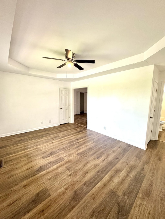 1306 Jared Ct, Clarksville, TN 37042 - empty room with a tray ceiling, baseboards, dark wood-style floors, and ceiling fan