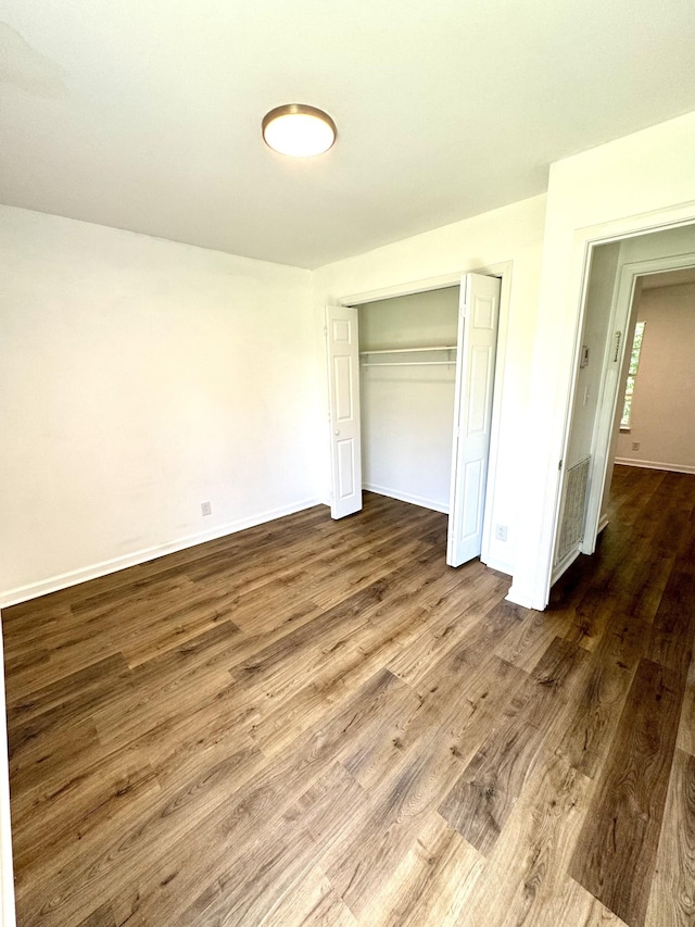 1306 Jared Ct, Clarksville, TN 37042 - unfurnished bedroom featuring dark wood finished floors, a closet, and baseboards