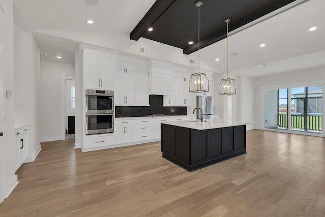 5735 Willoughby Way, Murfreesboro, TN 37129 - kitchen with stainless steel double oven, a chandelier, light wood finished floors, light countertops, and white cabinetry