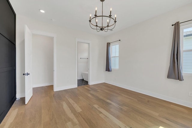 5735 Willoughby Way, Murfreesboro, TN 37129 - unfurnished dining area with a chandelier, light wood-style floors, and baseboards