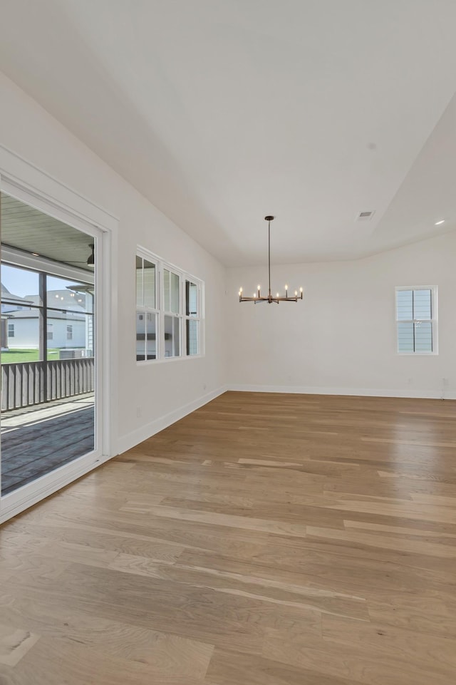 5735 Willoughby Way, Murfreesboro, TN 37129 - empty room with a chandelier, light wood-style floors, healthy amount of natural light, baseboards, and vaulted ceiling