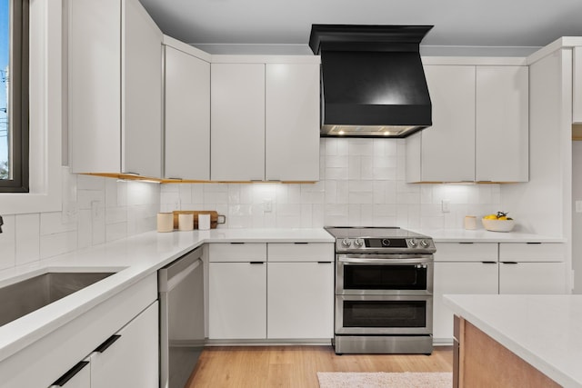 725 N Highland Ave, Murfreesboro, TN 37130 - kitchen with appliances with stainless steel finishes, custom exhaust hood, light countertops, and light wood-style floors