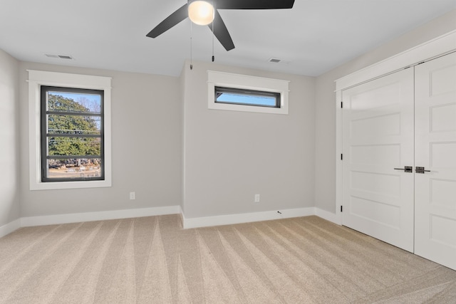 725 N Highland Ave, Murfreesboro, TN 37130 - unfurnished bedroom featuring multiple windows, light colored carpet, and baseboards