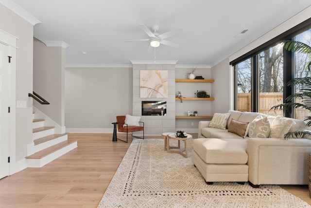 725 N Highland Ave, Murfreesboro, TN 37130 - living room with light wood-style flooring, a ceiling fan, ornamental molding, baseboards, and stairs