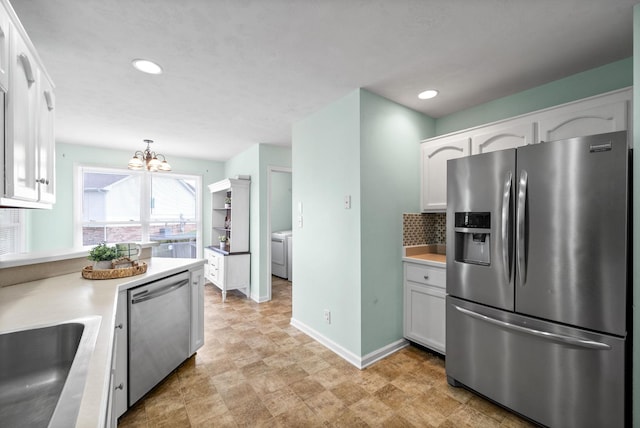3659 Fieldstone Dr, Clarksville, TN 37040 - kitchen with stainless steel appliances, washer / clothes dryer, white cabinetry, a chandelier, and recessed lighting