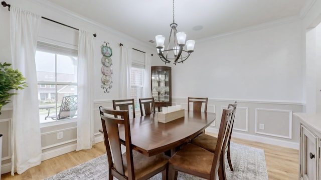 420 Fannis Cir, Gallatin, TN 37066 - dining area featuring a chandelier, healthy amount of natural light, light wood finished floors, a decorative wall, and crown molding