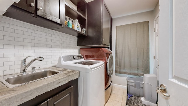 420 Fannis Cir, Gallatin, TN 37066 - clothes washing area featuring washing machine and clothes dryer, cabinet space, and light tile patterned floors