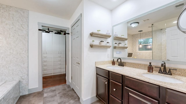 420 Fannis Cir, Gallatin, TN 37066 - bathroom featuring a tile shower, double vanity, and tile patterned flooring