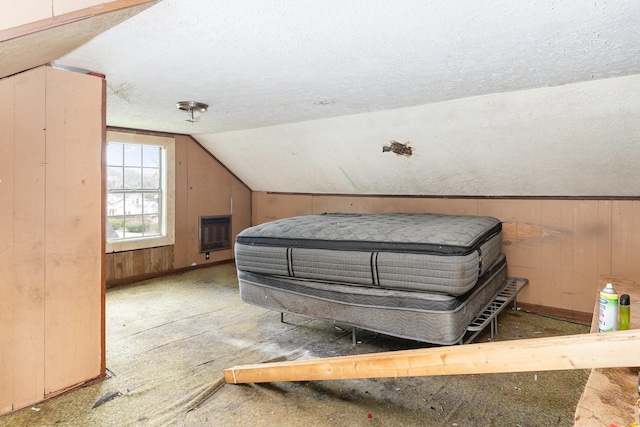 104 Lowe St, Ashland City, TN 37015 - bedroom featuring a textured ceiling, lofted ceiling, baseboards, wooden walls, and heating unit