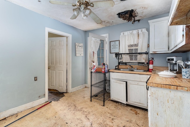 104 Lowe St, Ashland City, TN 37015 - kitchen featuring a ceiling fan, baseboards, a sink, white cabinetry, and light countertops