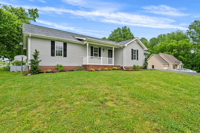 876 Oliver St, Scottsville, KY 42164 - ranch-style house featuring a porch, a front yard, roof with shingles, and a garage