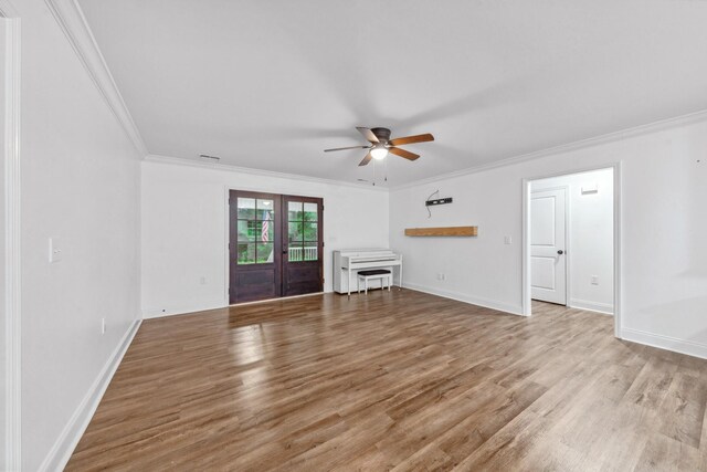 101 Henry Thompson Rd, Taft, TN 38488 - unfurnished living room with french doors, ornamental molding, wood finished floors, ceiling fan, and baseboards