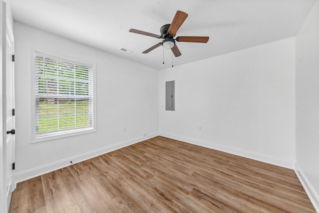 101 Henry Thompson Rd, Taft, TN 38488 - unfurnished room with wood finished floors, electric panel, a ceiling fan, and baseboards
