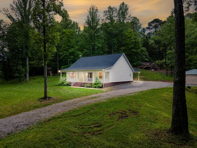 101 Henry Thompson Rd, Taft, TN 38488 - view of front of house featuring covered porch, dirt driveway, a front lawn, and a shingled roof