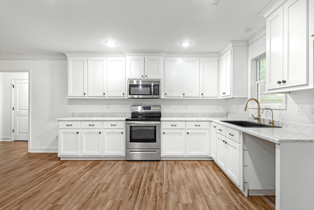 101 Henry Thompson Rd, Taft, TN 38488 - kitchen with appliances with stainless steel finishes, a sink, white cabinetry, ornamental molding, and recessed lighting