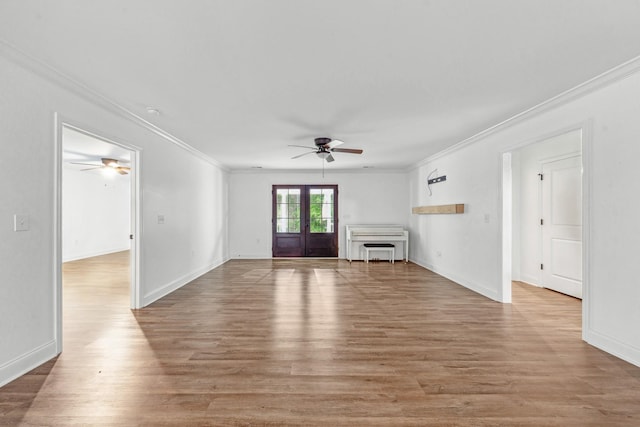 101 Henry Thompson Rd, Taft, TN 38488 - unfurnished living room with ceiling fan, crown molding, french doors, light wood-style floors, and baseboards