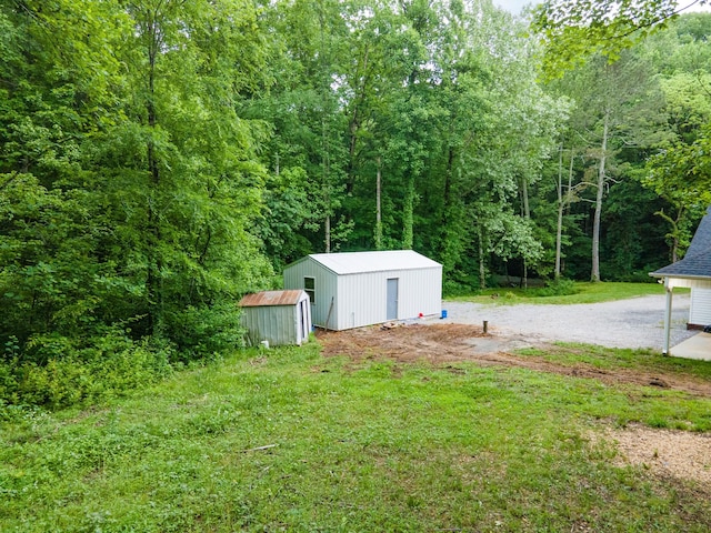101 Henry Thompson Rd, Taft, TN 38488 - view of yard featuring an outbuilding and a wooded view