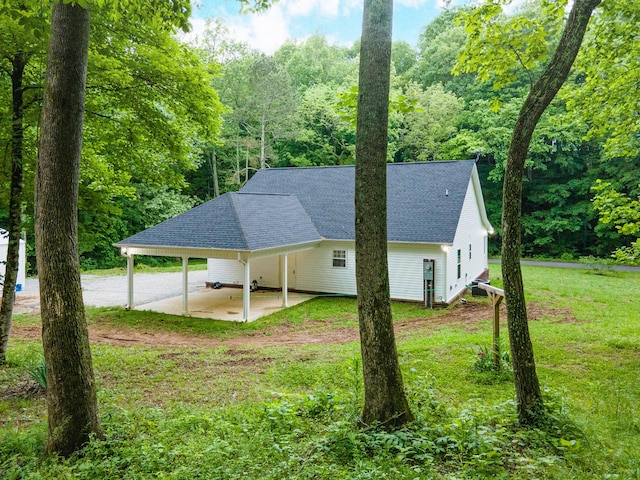 101 Henry Thompson Rd, Taft, TN 38488 - view of property exterior with a shingled roof, a yard, and a carport