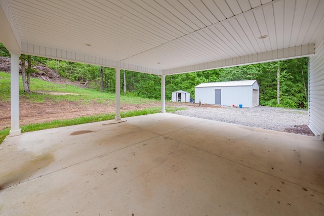 101 Henry Thompson Rd, Taft, TN 38488 - view of patio featuring an outdoor structure, a storage shed, and a carport