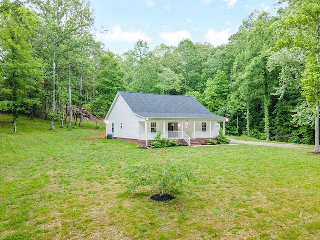 101 Henry Thompson Rd, Taft, TN 38488 - view of front of property featuring covered porch, a front yard, a view of trees, and roof with shingles