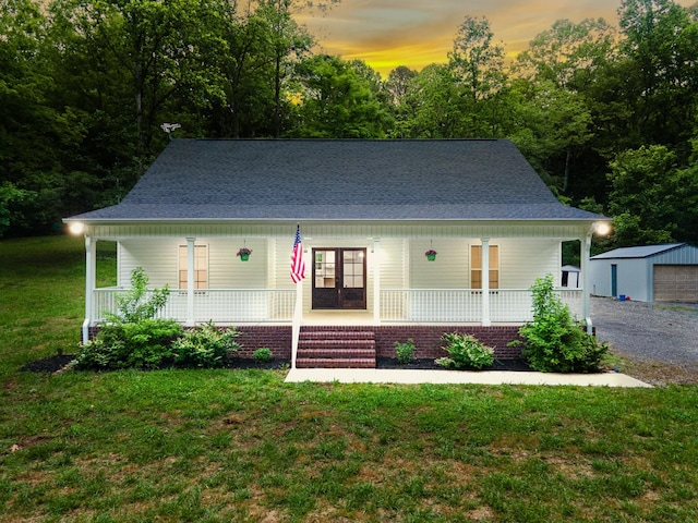 101 Henry Thompson Rd, Taft, TN 38488 - country-style home featuring covered porch, a lawn, a shingled roof, and an outdoor structure