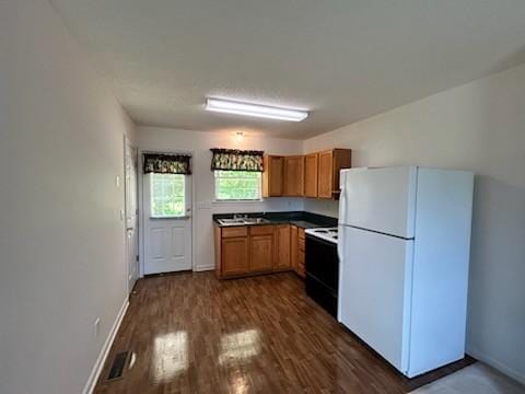 1368 Pleasant Hill Rd, Lynchburg, TN 37352 - kitchen featuring freestanding refrigerator, electric range, baseboards, and dark wood-style floors