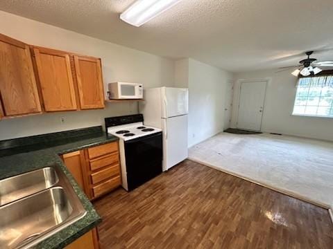 1368 Pleasant Hill Rd, Lynchburg, TN 37352 - kitchen with white appliances, a sink, dark countertops, dark wood finished floors, and ceiling fan