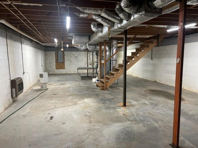 1368 Pleasant Hill Rd, Lynchburg, TN 37352 - unfinished basement with electric panel, heating unit, concrete block wall, and stairway