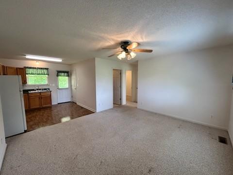 1368 Pleasant Hill Rd, Lynchburg, TN 37352 - unfurnished living room with ceiling fan, carpet flooring, and baseboards