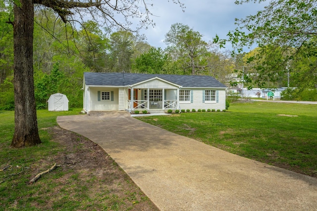 9039 Dallas Hollow Rd, Soddy Daisy, TN 37379 - single story home with covered porch, a storage unit, concrete driveway, a front lawn, and an outbuilding