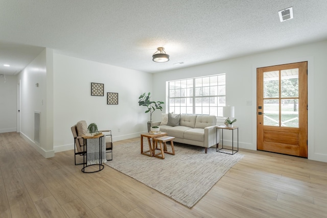9039 Dallas Hollow Rd, Soddy Daisy, TN 37379 - living room with light wood-type flooring, baseboards, a textured ceiling, and attic access
