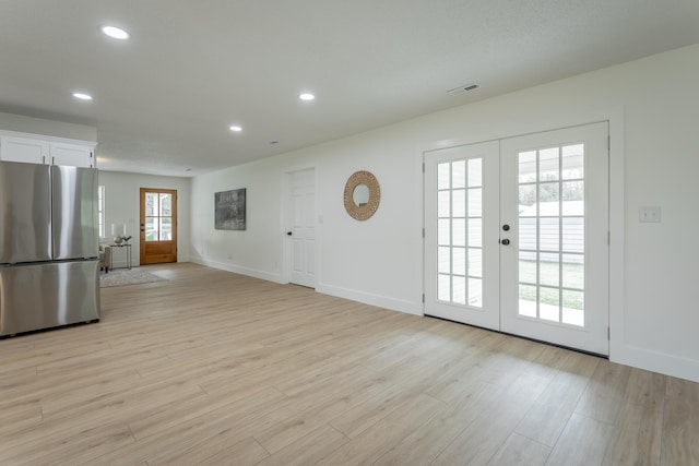 9039 Dallas Hollow Rd, Soddy Daisy, TN 37379 - unfurnished living room featuring french doors, recessed lighting, light wood-style floors, and baseboards