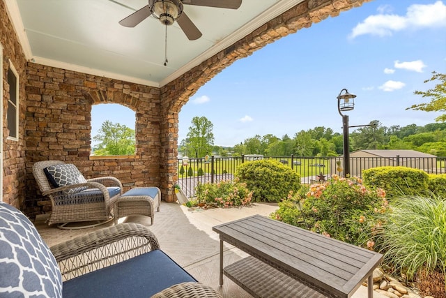 view of patio featuring a ceiling fan and fence