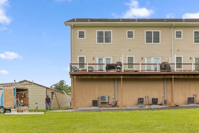 rear view of house with a lawn and central AC unit