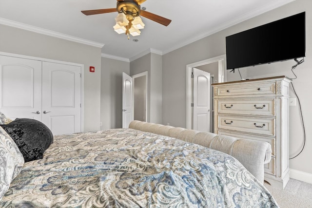 carpeted bedroom with crown molding, a closet, a ceiling fan, and baseboards