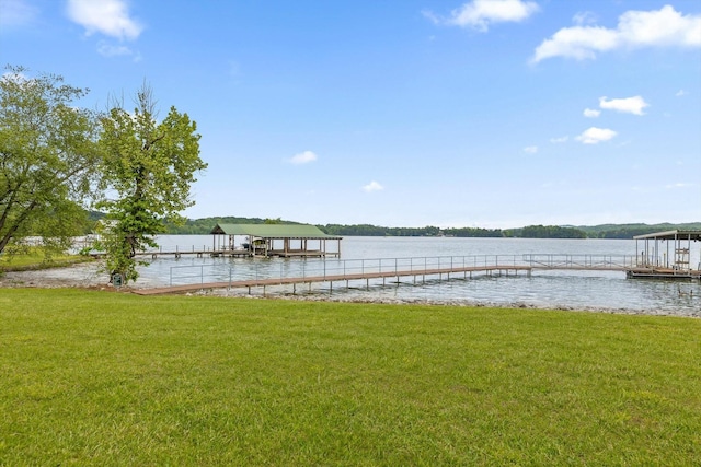 dock featuring a lawn and a water view