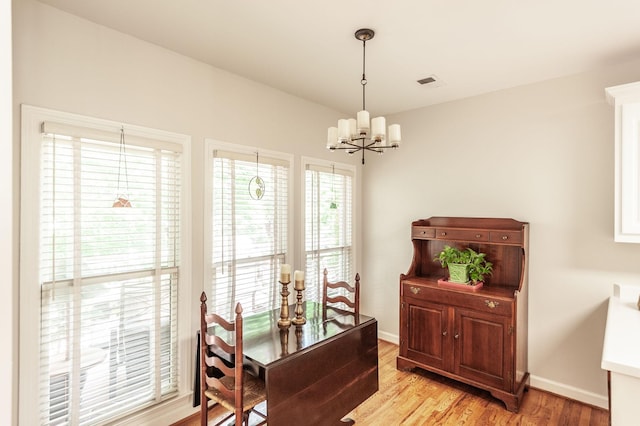 6737 Autumnwood Dr, Nashville, TN 37221 - dining space featuring a chandelier, light wood-style floors, and baseboards