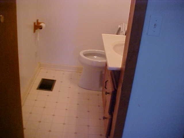 bathroom with vanity, tile patterned floors, toilet, and baseboards