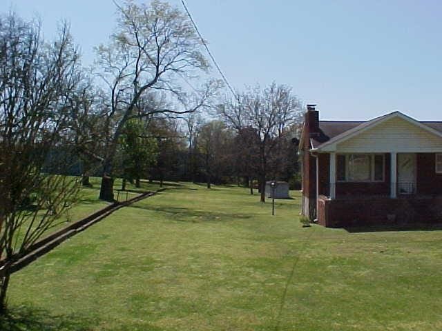 view of grassy yard featuring a porch