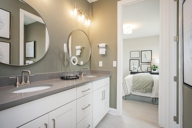 5969 Hunt Valley Dr, Spring Hill, TN 37174 - ensuite bathroom featuring double vanity, tile patterned floors, and baseboards