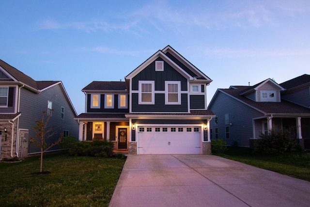 craftsman-style home featuring board and batten siding, driveway, an attached garage, a front lawn, and covered porch
