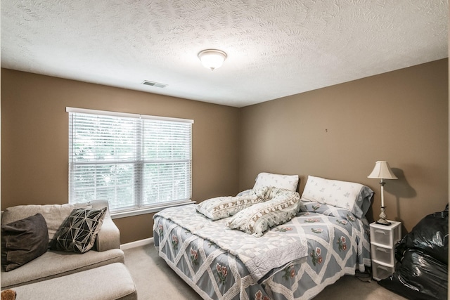 bedroom featuring carpet flooring, baseboards, and a textured ceiling