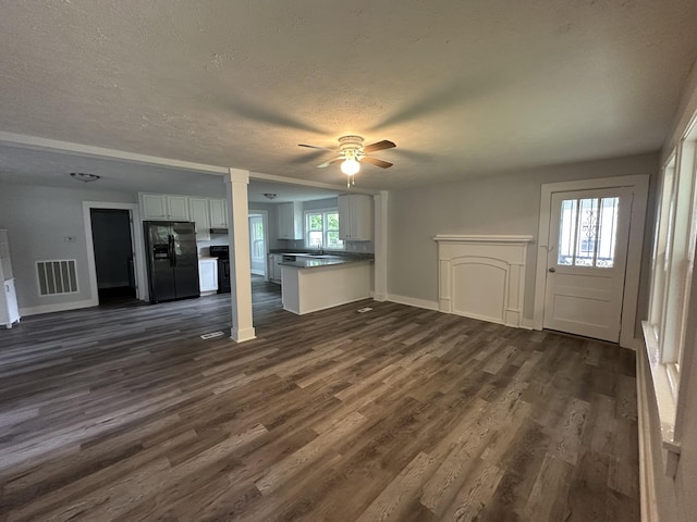 105 Murfreesboro St, Murfreesboro, TN 37127 - unfurnished living room with dark wood-style flooring, a ceiling fan, baseboards, a textured ceiling, and a sink