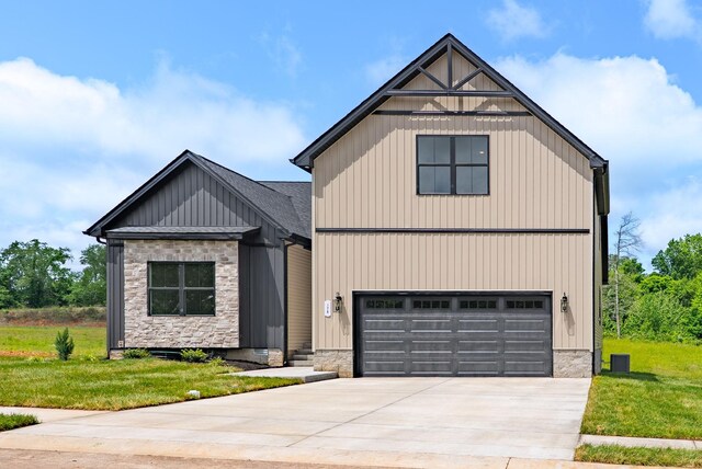 178 Dewberry Ct, Clarksville, TN 37042 - view of front of property with a front lawn, stone siding, board and batten siding, concrete driveway, and a garage