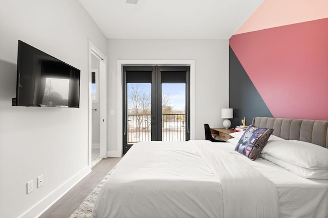 bedroom with french doors, access to exterior, wood finished floors, and baseboards