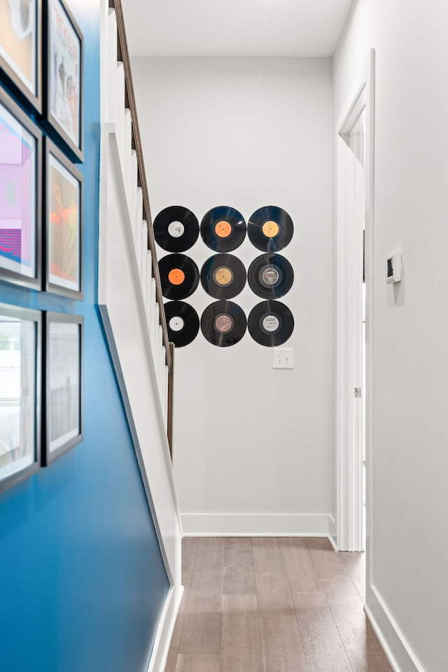 hall featuring baseboards and stairs