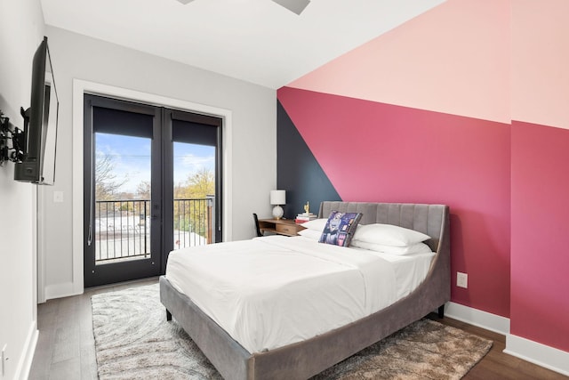 bedroom featuring access to outside, wood finished floors, and baseboards