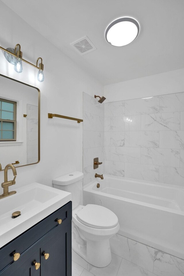 full bathroom featuring marble look tile flooring, toilet, vanity, and shower / tub combination